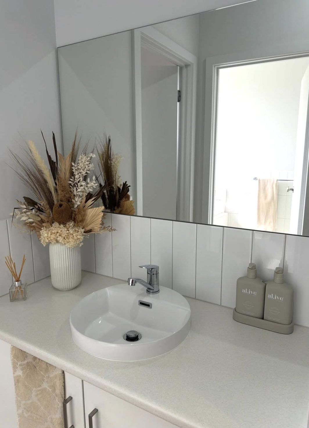 Bathroom vanity, basin and mirror after cleaning