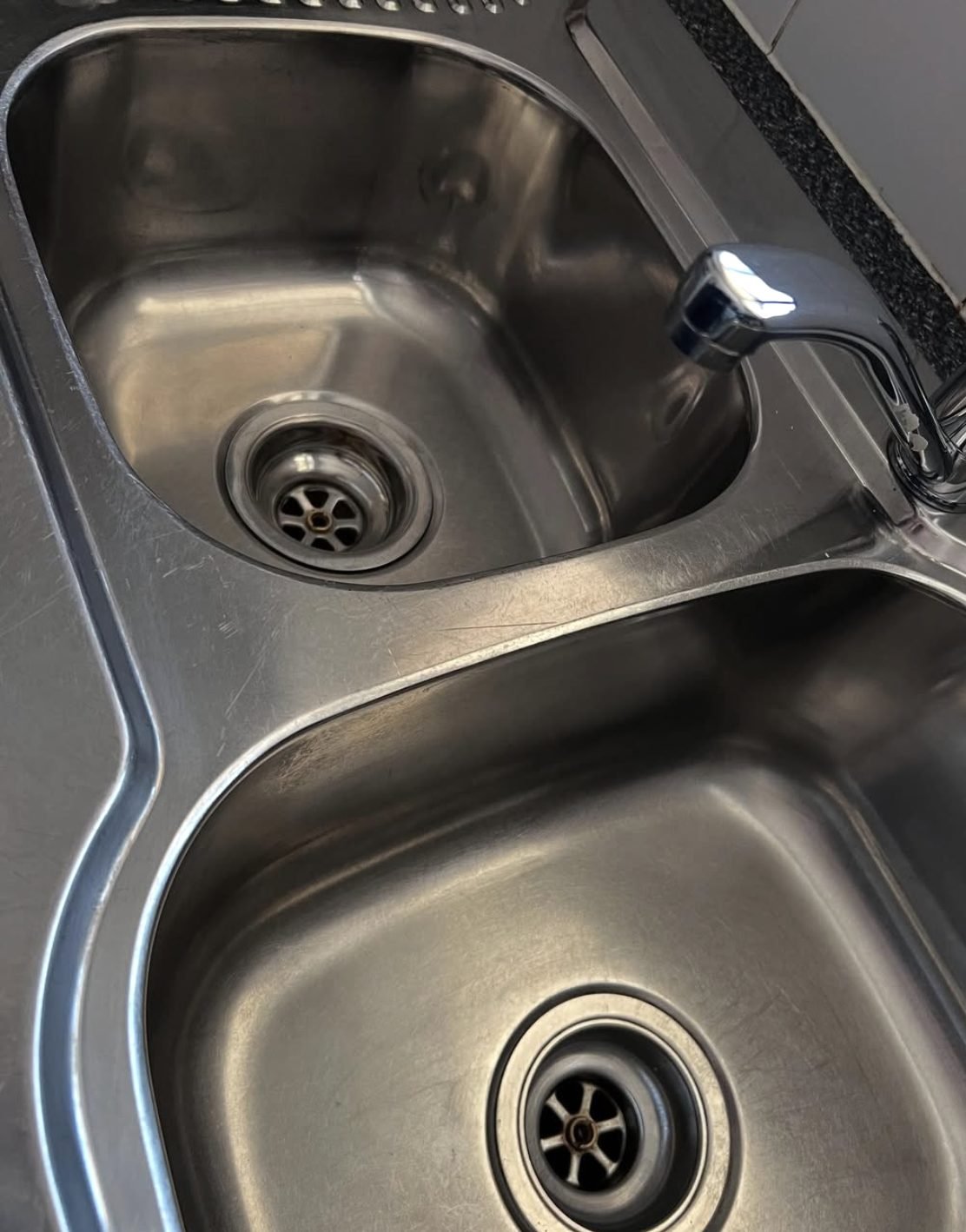 Stainless steel sink and taps cleaned and polished